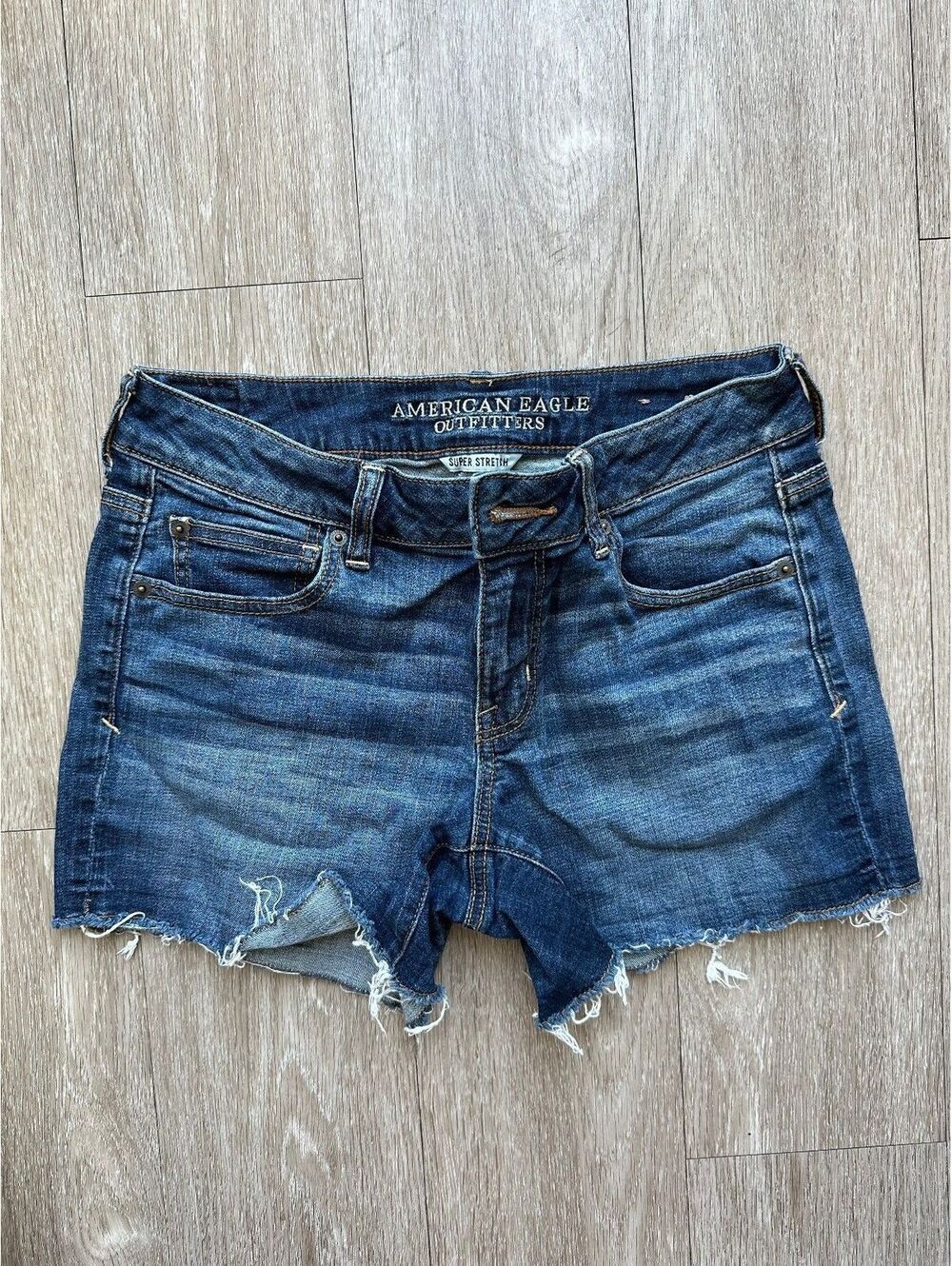 American Eagle Women's mid rise dark wash distressed demin shorts